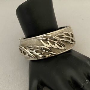 Vintage silver tone clamper bangle with raised leaf design